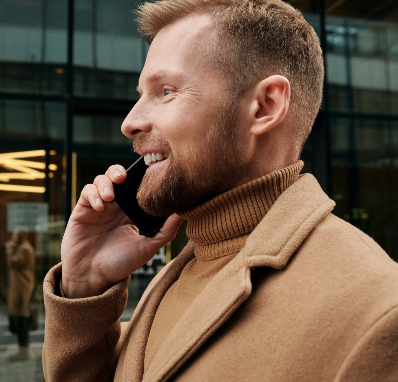 man talking on the phone while walking outside 