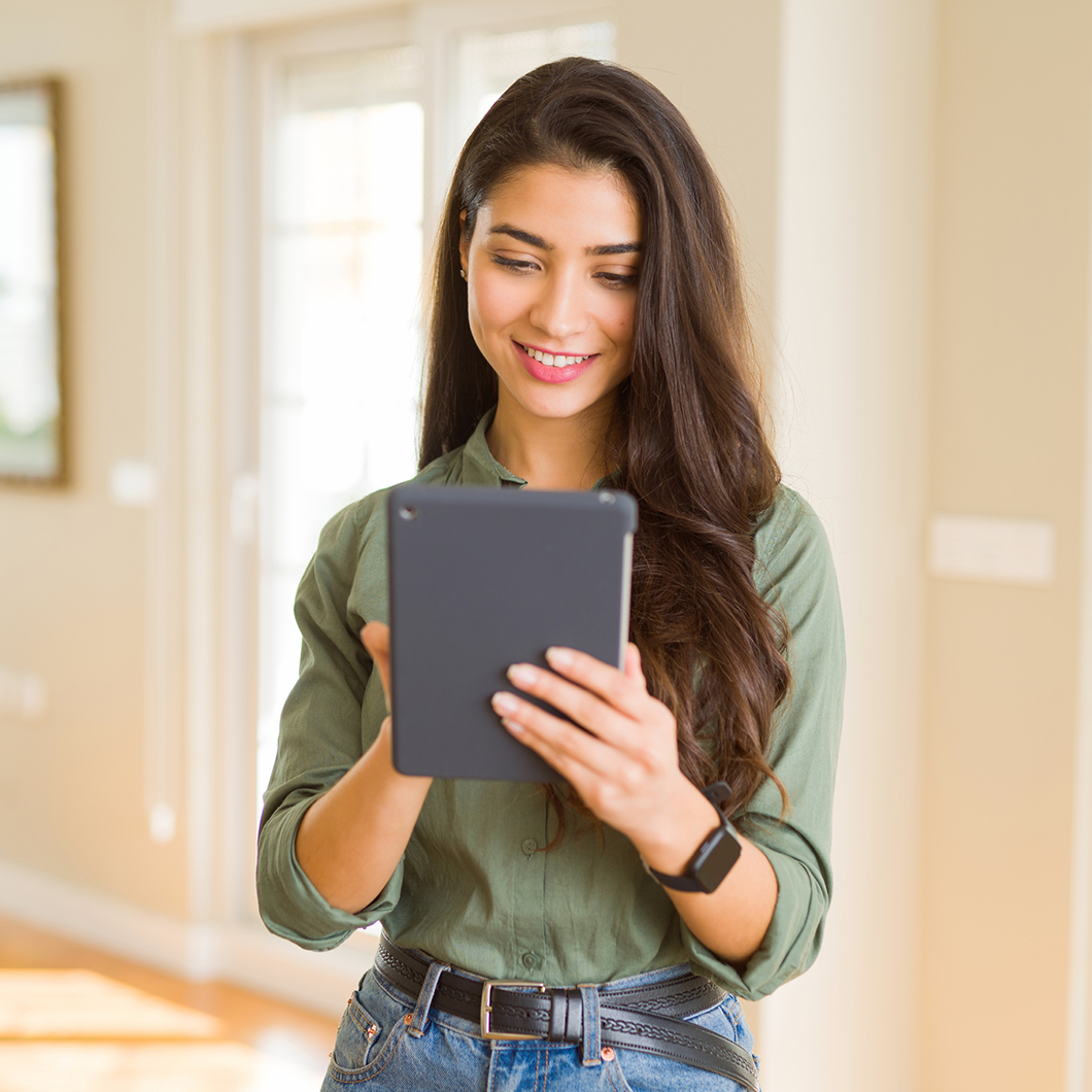 woman smiling holding tablet